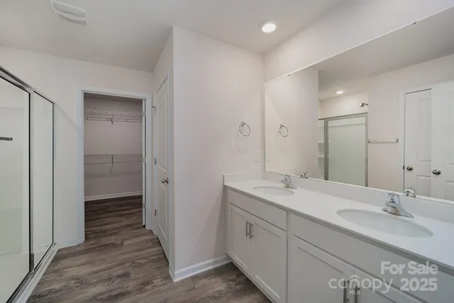 a bathroom with a glass shower door