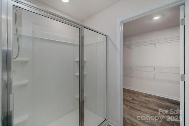 a bathroom that has a glass shower door