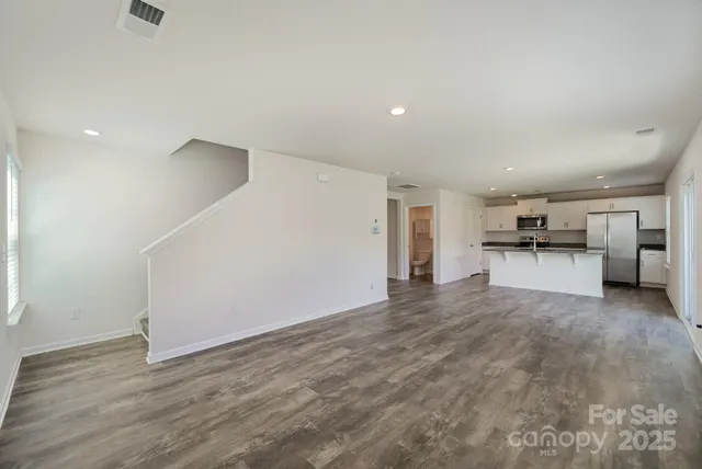 a view of a kitchen with a sink and a refrigerator