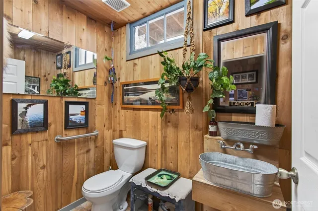a bathroom with a toilet sink and mirror