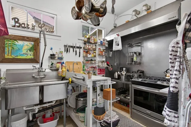 a kitchen with stainless steel appliances granite countertop a stove and a sink
