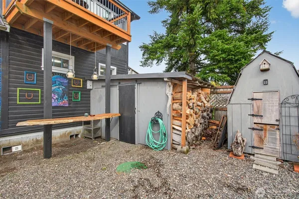 a backyard of a house with barbeque oven table and chairs