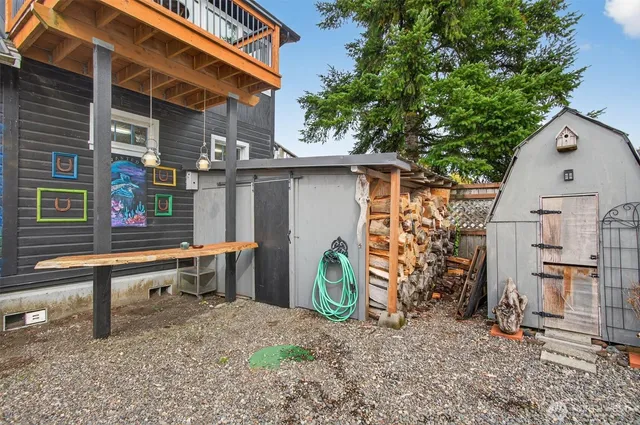 a backyard of a house with barbeque oven table and chairs