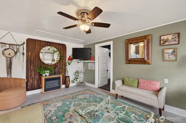 a living room with furniture a rug and a large window