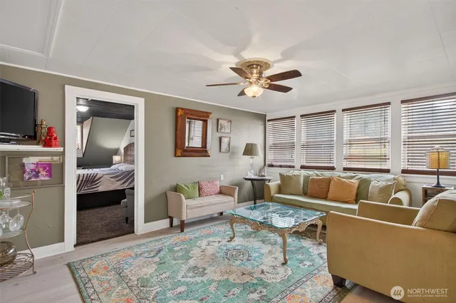 a bedroom with a bed and a chair with the wooden floor