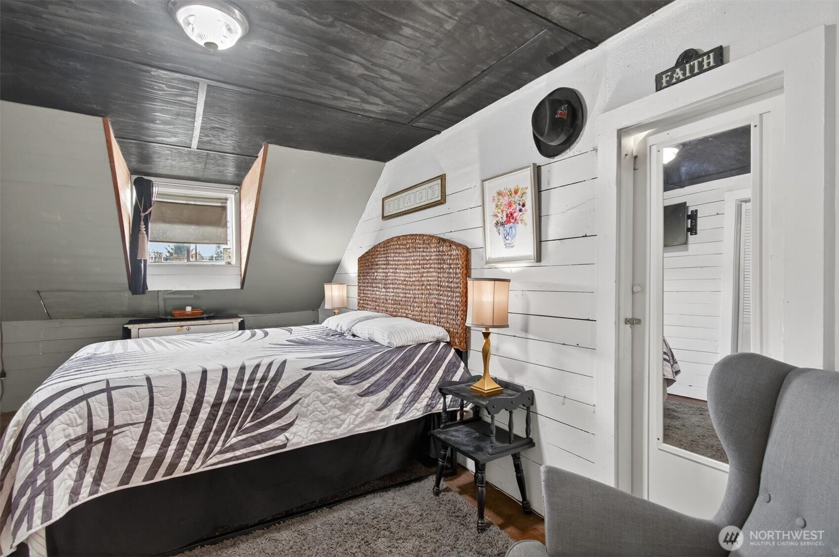 8 Fairgrounds Road Skamokawa, WA 98647 - Photo 31 of 40 a bedroom with a bed and a chair with the wooden floor