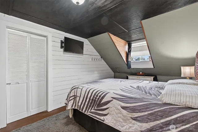 a living room with furniture wooden floor and a large window