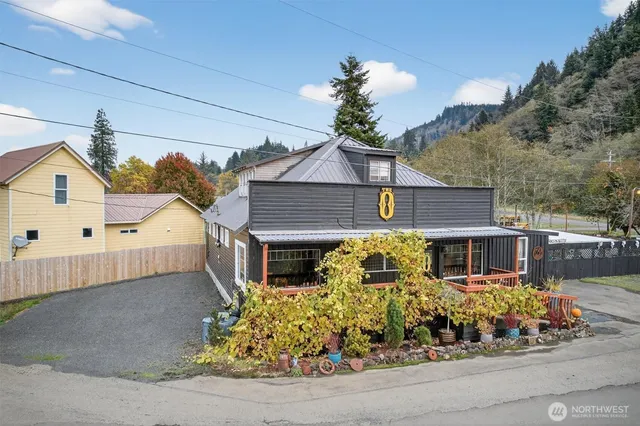 an aerial view of a house with garden space and mountain view