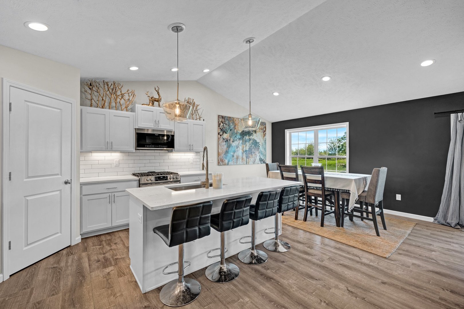 277 Cassidy Road Normal, IL 61761 - Photo 10 of 42 a kitchen with stainless steel appliances granite countertop a stove a refrigerator a kitchen island a dining table and chairs with wooden floor