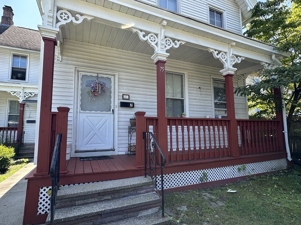 75 Parker Street Springfield, MA 01151 - Photo 5 of 28 a view of a house with a small yard and wooden fence