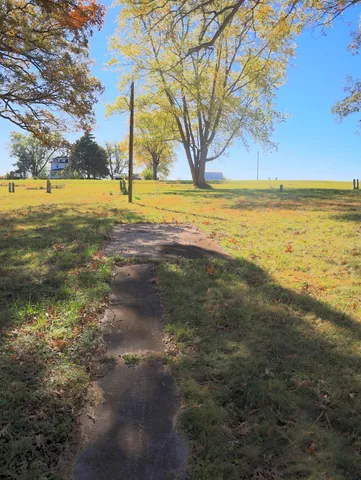 a view of a field with an ocean