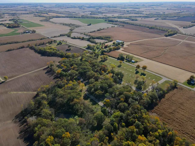 an aerial view of a house with a yard and lake view