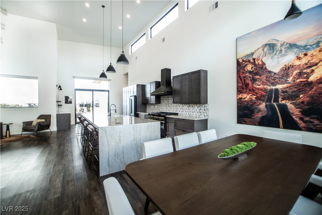 3030 South Formula Court Pahrump, NV 89048 - Photo 16 of 48 Dining space featuring plenty of natural light, sink, dark wood-type flooring, and a towering ceiling