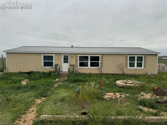 a backyard of a house with yard and outdoor seating