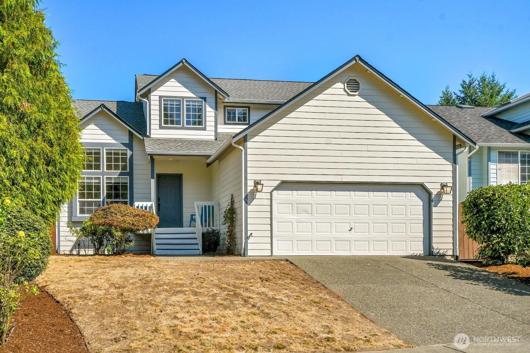 a view of a house with a yard and garage