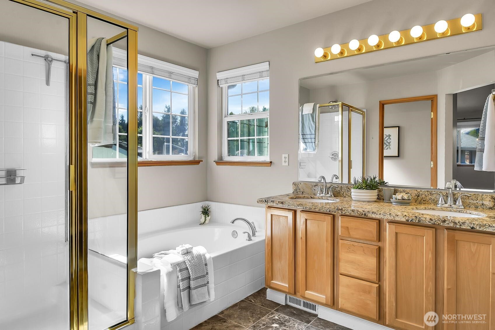 18524 114th Avenue Southeast Renton, WA 98055 - Photo 16 of 20 a bathroom with a granite countertop tub sink and mirror
