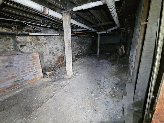 a front view of a house with a yard covered in snow
