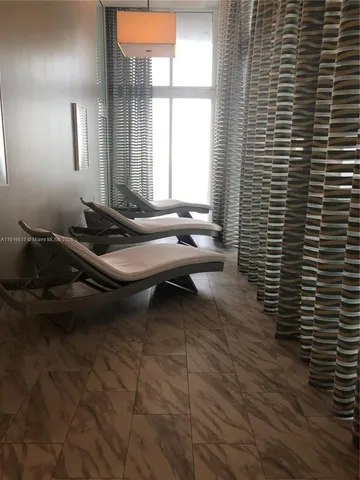 a room with pool table and windows