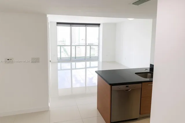 a kitchen with granite countertop a sink and a stove