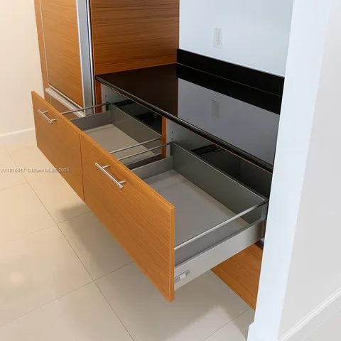 a bedroom with a large bed and a potted plant