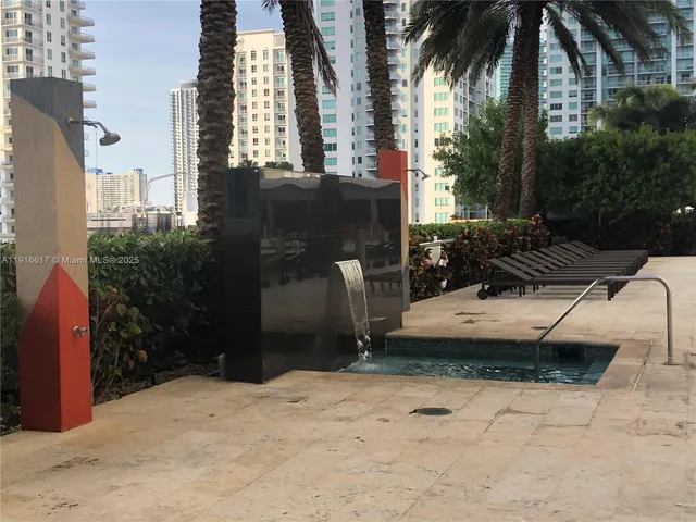 a view of backyard with barbeque grill and potted plants