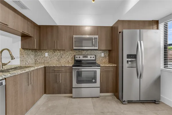 a kitchen with a refrigerator sink and stove