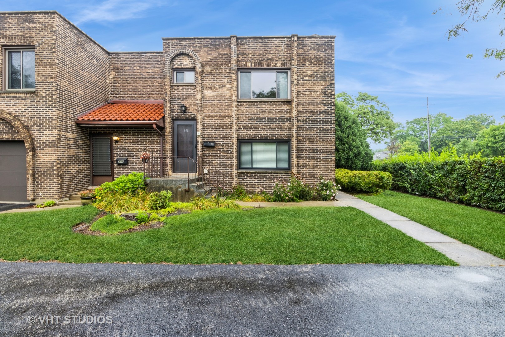 348 East Rimini Court, Unit 348 Palatine, IL 60067 - Photo 1 of 10 a brick building with a yard