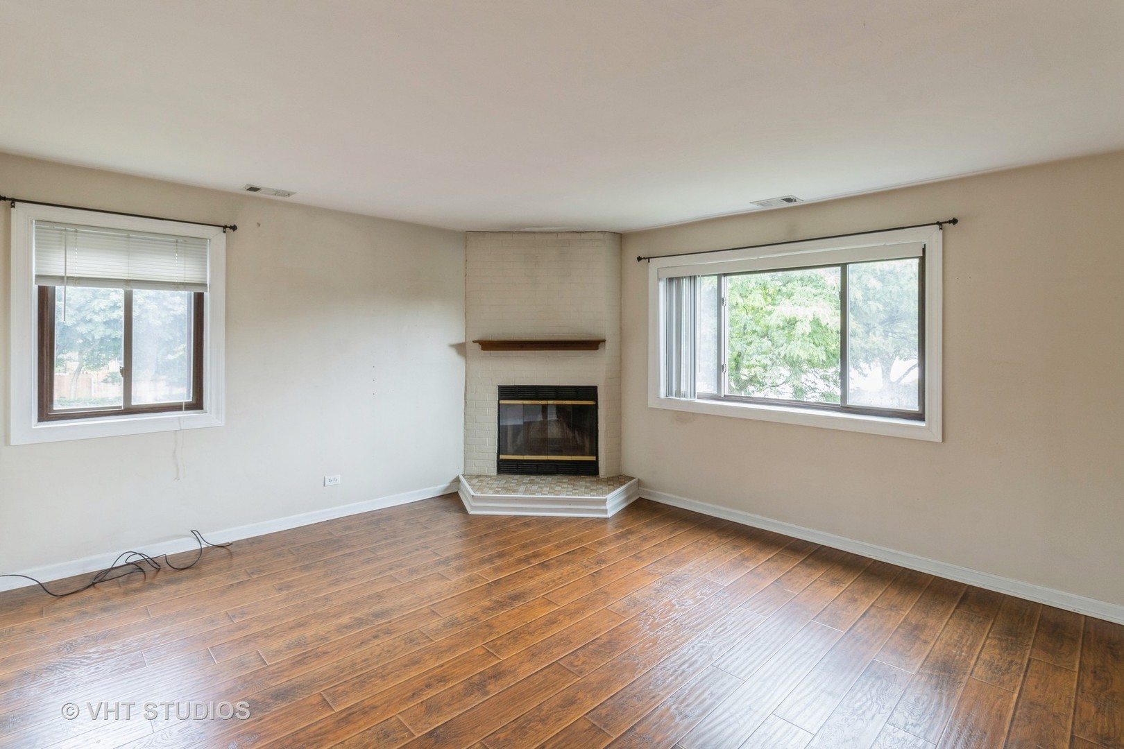 348 East Rimini Court, Unit 348 Palatine, IL 60067 - Photo 2 of 10 a view of an empty room with wooden floor and a window