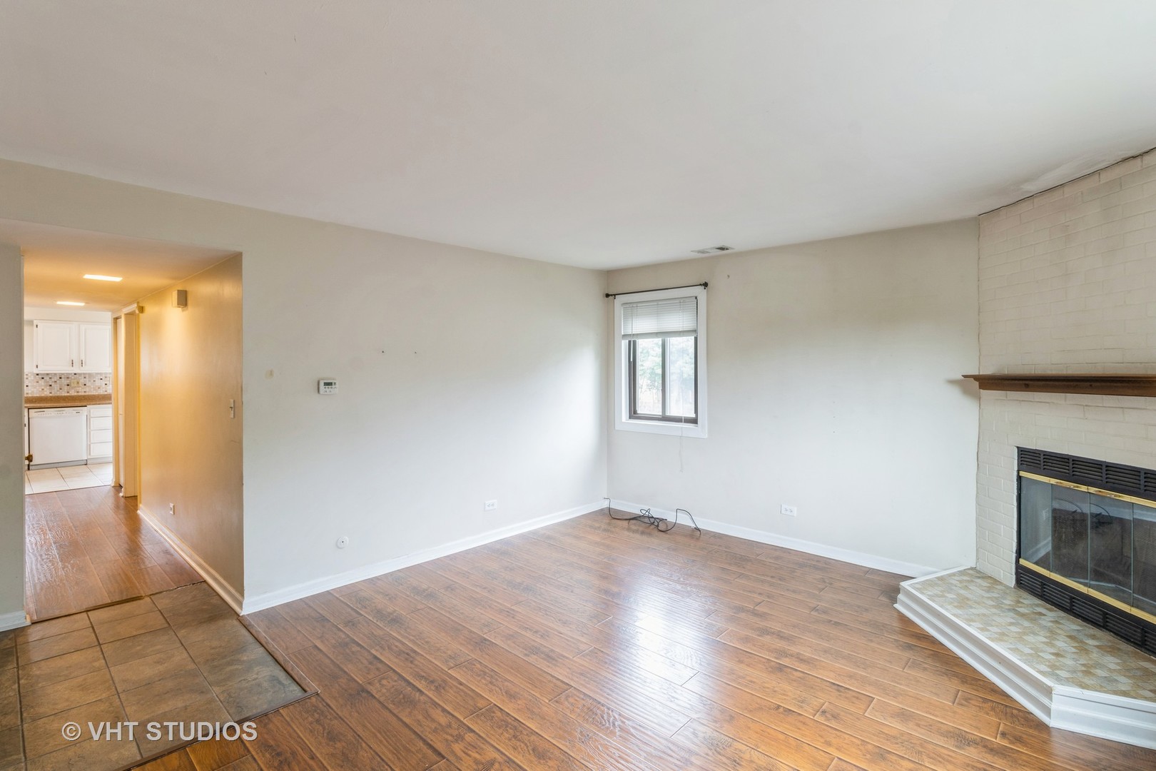 348 East Rimini Court, Unit 348 Palatine, IL 60067 - Photo 3 of 10 wooden floor in an empty room with a fireplace