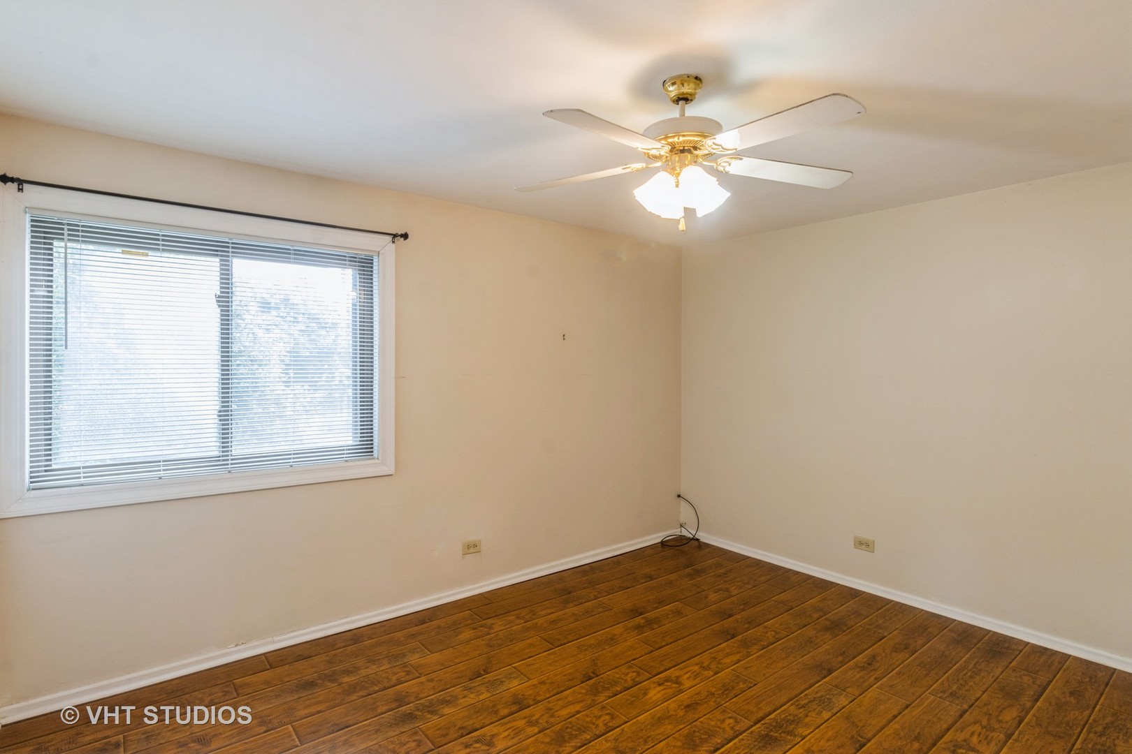 348 East Rimini Court, Unit 348 Palatine, IL 60067 - Photo 7 of 10 a view of an empty room with wooden floor and a window