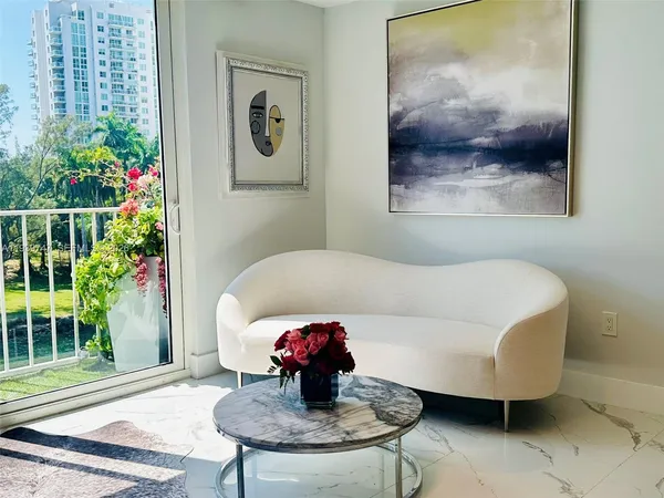 a living room with furniture and a potted plant