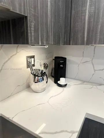 a kitchen with a refrigerator and a stove