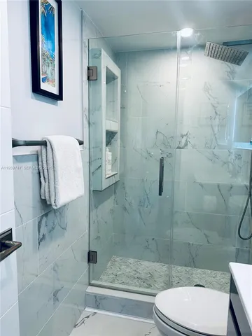 a bathroom with a toilet and shower