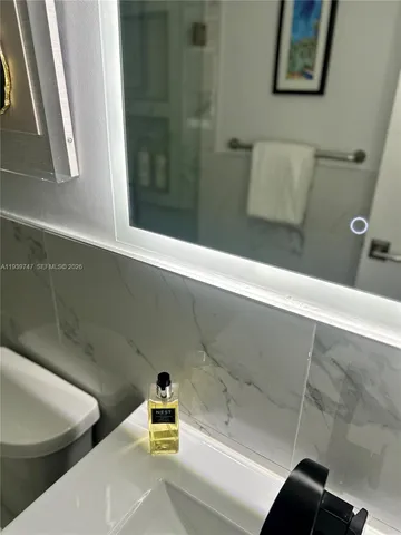 a bedroom with a bed and a large mirror