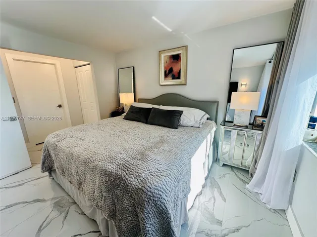 a spacious bedroom with a bed and a window