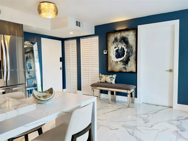 a view of a livingroom with furniture and mirror