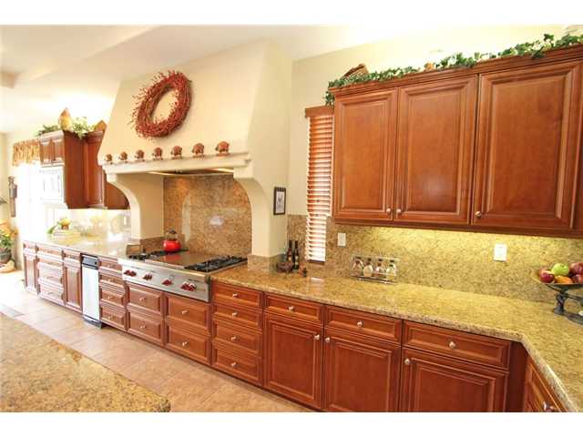 Beautiful kitchen complete with granite counters and backsplash and custom cabinetry.