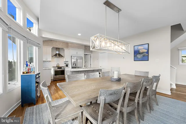 a view of a dining room with furniture a chandelier and wooden floor