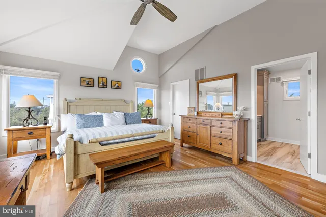 a spacious bedroom with furniture and a table