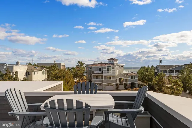 a view of a balcony dining table and chairs
