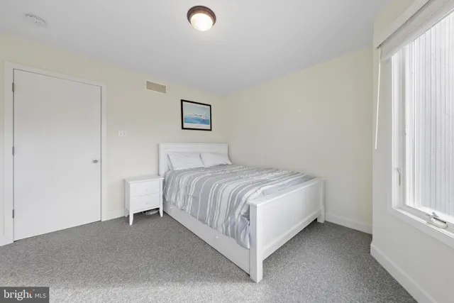 a bed room with a bed and a window