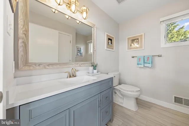 a bathroom with a sink toilet and a mirror
