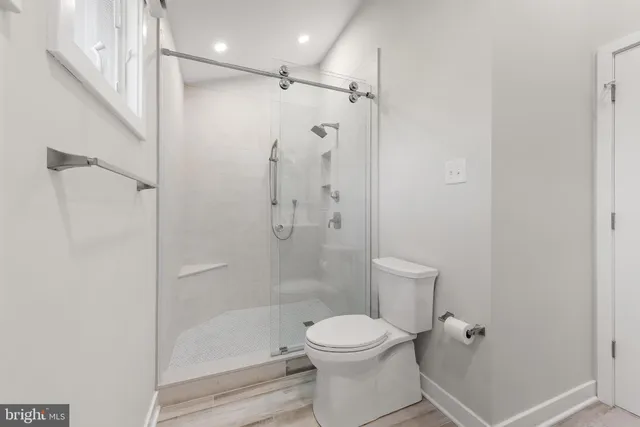 a bathroom with a shower a toilet and a shower