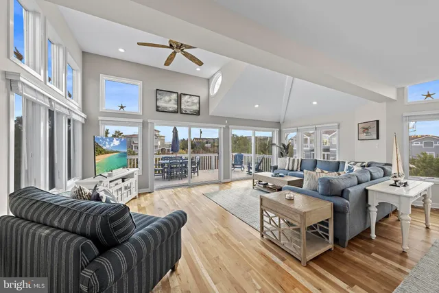 a living room with furniture large windows and a rug