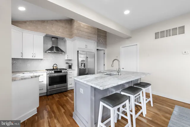 a kitchen with stainless steel appliances a sink and stove