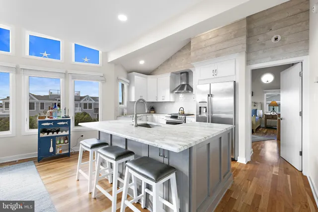 a large kitchen with a table and chairs