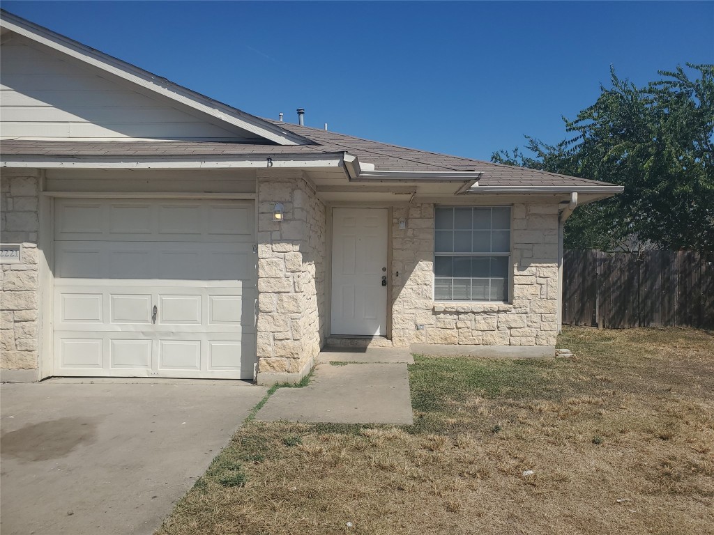 2221 Creekside Lane, Unit B Georgetown, TX 78626 - Photo 1 of 33 View of front of property with stone siding, roof with shingles, an attached garage, and driveway