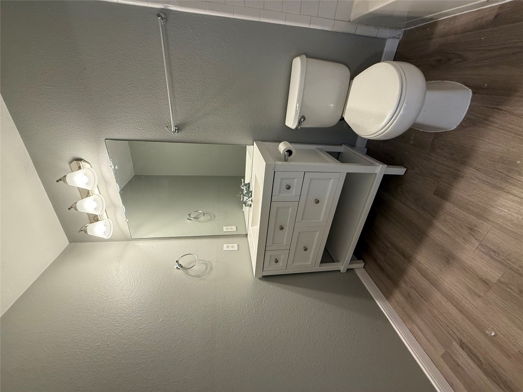 2221 Creekside Lane, Unit B Georgetown, TX 78626 - Photo 11 of 33 Full bathroom featuring vanity, a textured wall, and light wood-style flooring