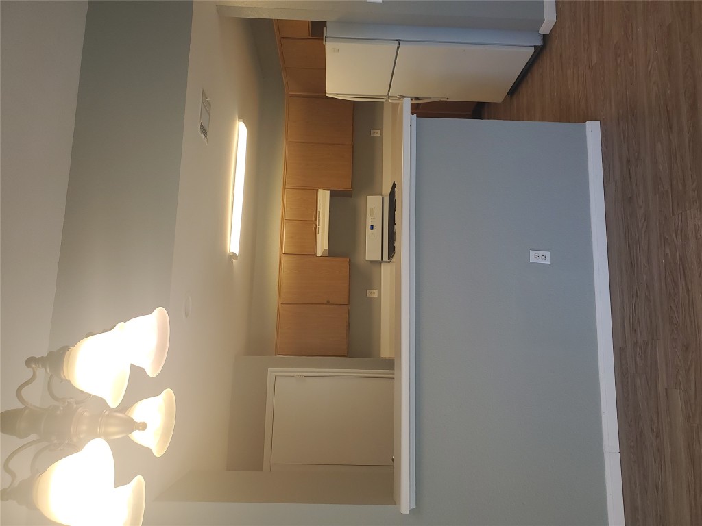 2221 Creekside Lane, Unit B Georgetown, TX 78626 - Photo 15 of 33 Kitchen featuring light countertops, fridge, dark wood-style floors, stainless steel range, and extractor fan