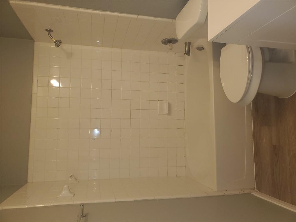 2221 Creekside Lane, Unit B Georgetown, TX 78626 - Photo 19 of 33 Bathroom featuring shower combination, vanity, and dark wood-style flooring
